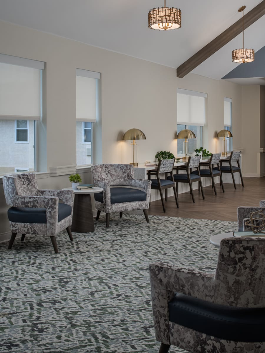Lounge with armchairs arranged around a fireplace