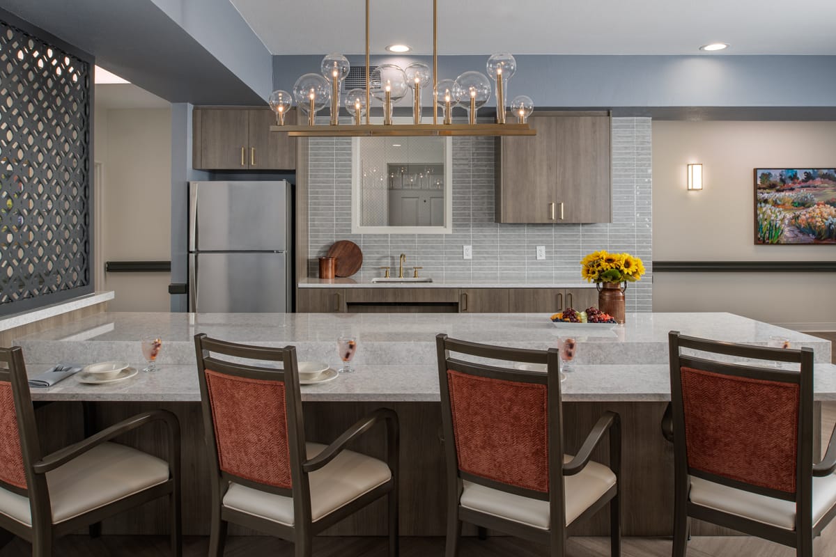 Demonstration kitchen with a stone island and counter seating